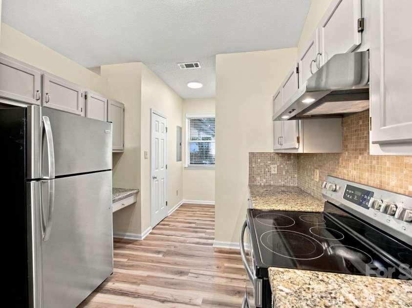 19838 Oak Leaf Circle, Cornelius, NC 28031.  MLS# CAR4429778, YatesRealty ID 54063. Kitchen stove, countertop space and refrigerator