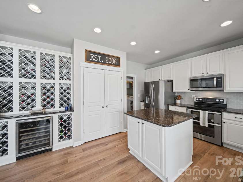 3604 Grovecreek Pond Drive, Concord, NC 28027.  MLS# CAR4428204, YatesRealty ID 54089. Kitchen with 111 bottle wine rack
