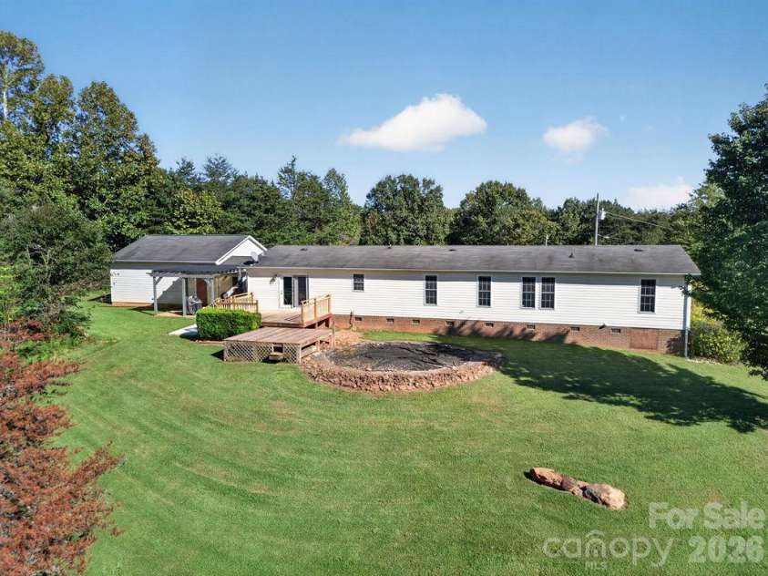 6041 Kaylas Ridge Road, Connelly Springs, NC 28612.  MLS# CAR4429448, YatesRealty ID 54091. Backyard with platform and base for a pool