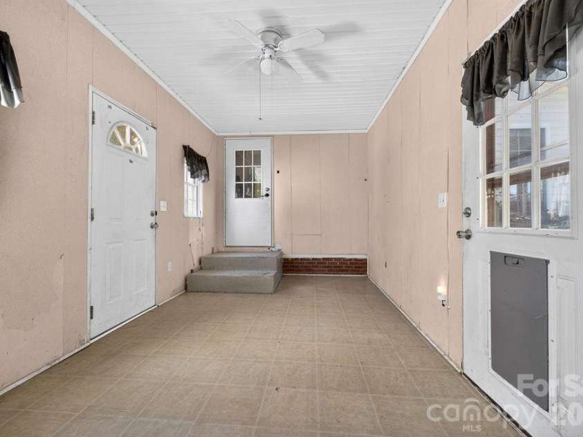 6041 Kaylas Ridge Road, Connelly Springs, NC 28612.  MLS# CAR4429448, YatesRealty ID 54091. Breezeway from main house with exits to front, backyard and garage