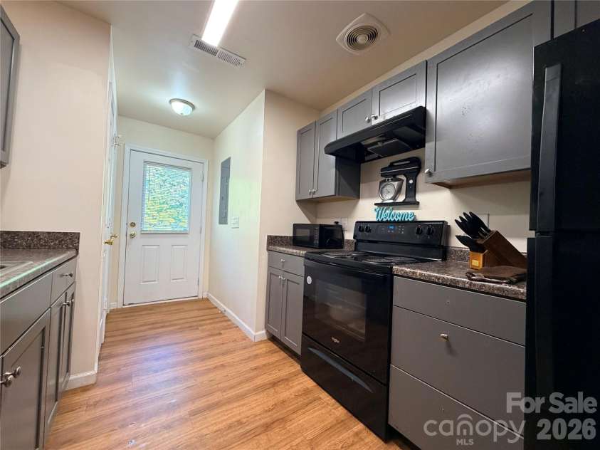 368 Mills Avenue, Mooresville, NC 28115.  MLS# CAR4416647, YatesRealty ID 54106. Kitchen features range, dishwasher, refrigerator, ample cabinetry