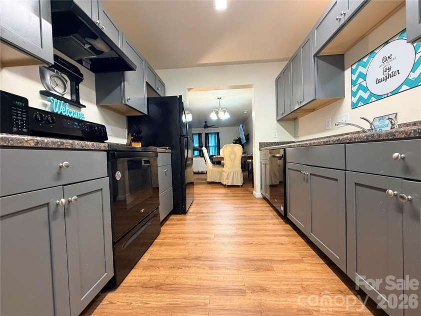 368 Mills Avenue, Mooresville, NC 28115.  MLS# CAR4416647, YatesRealty ID 54106. Kitchen view from back entry with convenient flow into main living area