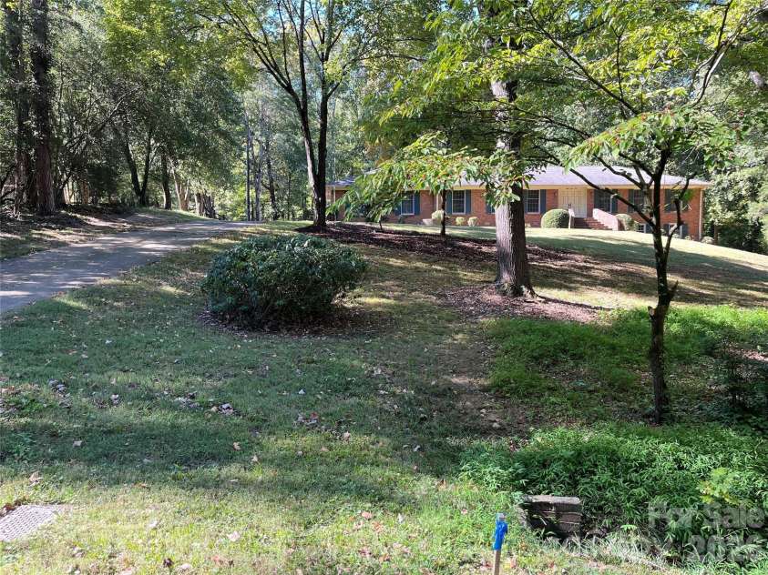 8310 County Downs Lane, Charlotte, NC 28270.  MLS# CAR4429760, YatesRealty ID 54128. Exterior pic showing land and sf - Front view