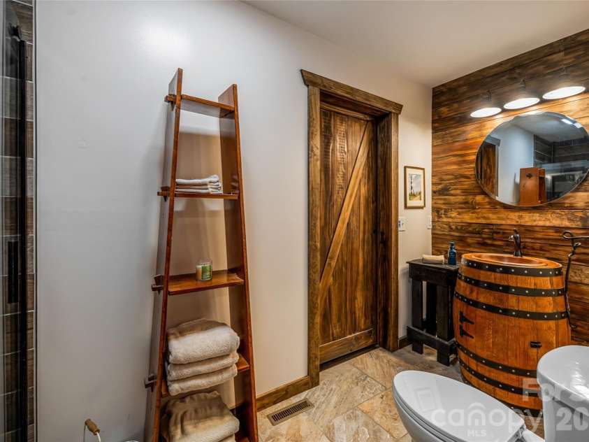 19 Forge Drive, Mills River, NC 28759.  MLS# CAR4429305, YatesRealty ID 54159. Ensuite Full Bath with Rain Barrel Vanity and Shiplap Wall Accent