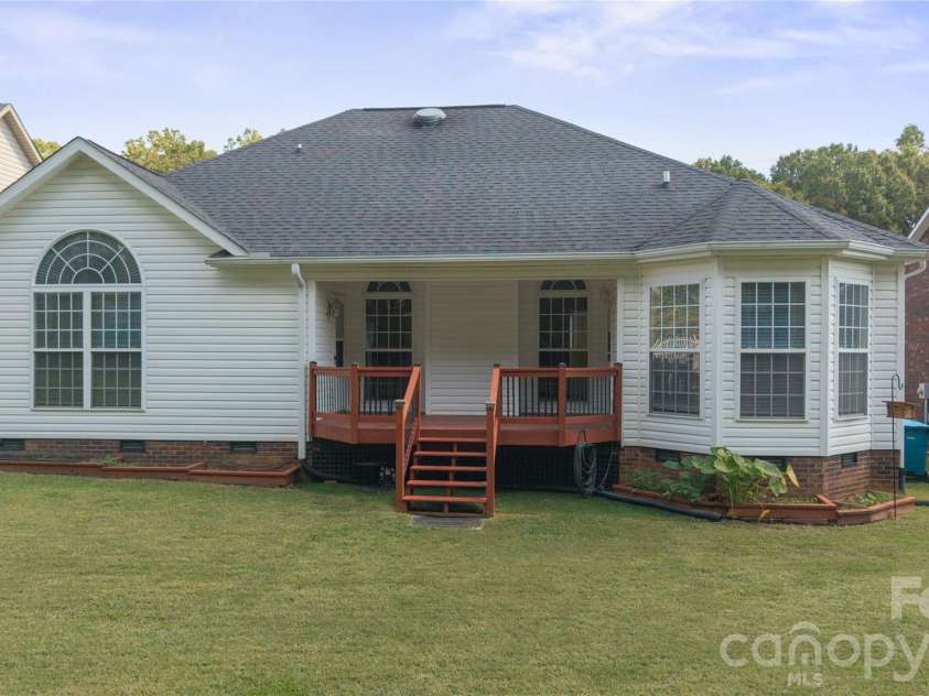 1011 Overhill Drive, Salisbury, NC 28144.  MLS# CAR4429292, YatesRealty ID 54283. Spacious, grassy backyard featuring a wooden covered deck, low-maintenance vinyl siding, large sun-filling windows, and bay window nook.