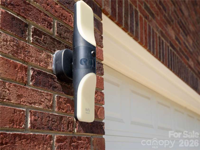 1011 Overhill Drive, Salisbury, NC 28144.  MLS# CAR4429292, YatesRealty ID 54283. Two Eufy floodlight cameras on either side of the garage with color changing light effects