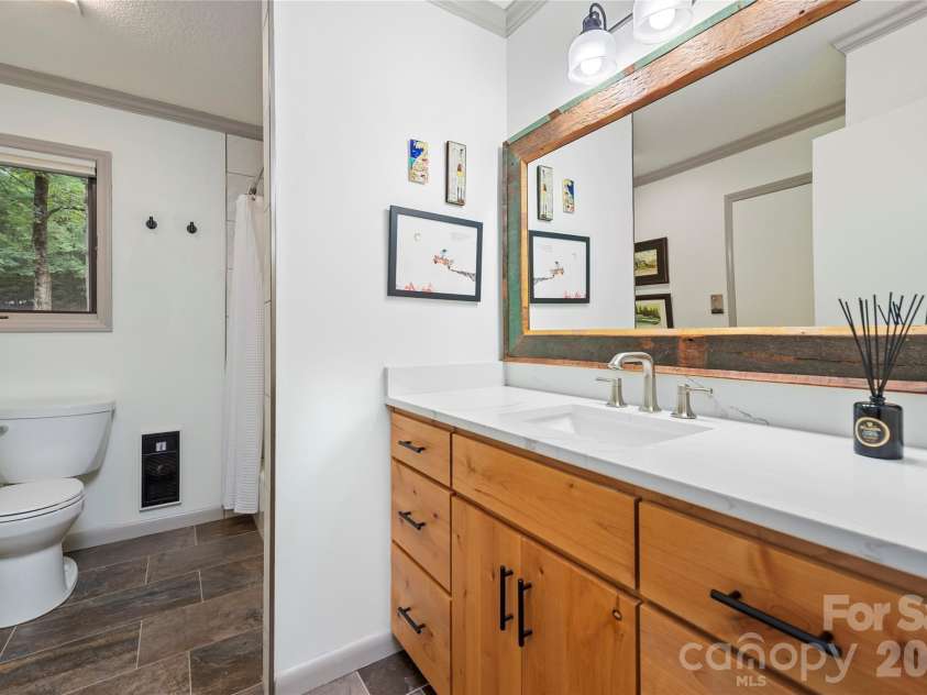 109 Middle Connestee Trail, Brevard, NC 28712.  MLS# CAR4429335, YatesRealty ID 54285. Alder cabinets are also echoed in this