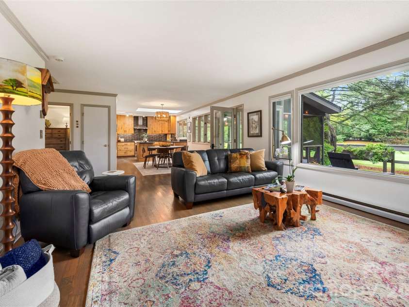 109 Middle Connestee Trail, Brevard, NC 28712.  MLS# CAR4429335, YatesRealty ID 54285. The open floor plan leads to the living space complete with an oversized picture window