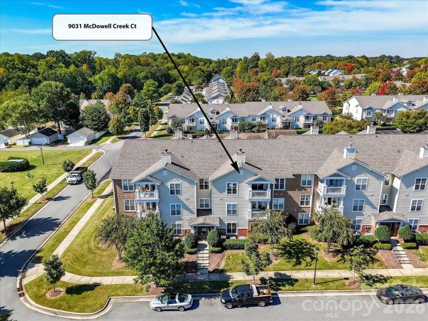9031 Mcdowell Creek Court, Cornelius, NC 28031.  MLS# CAR4428404, YatesRealty ID 54302. Aerial view highlights the condo’s location within the building, offering an elevated position overlooking the well-maintained community surroundings.