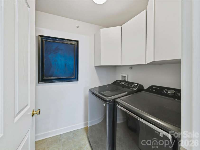 9031 Mcdowell Creek Court, Cornelius, NC 28031.  MLS# CAR4428404, YatesRealty ID 54302. Convenient laundry room featuring overhead cabinetry for added storage, and easy access from the kitchen area.