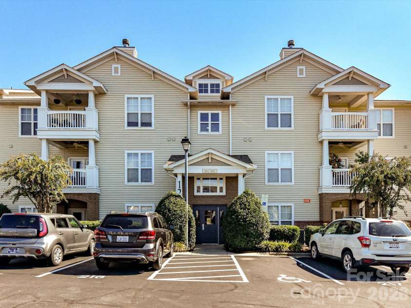 9031 Mcdowell Creek Court, Cornelius, NC 28031.  MLS# CAR4428404, YatesRealty ID 54302. Convenient rear building entrance featuring a covered entry, secure access, and well-maintained landscaping for easy everyday access to the condo.