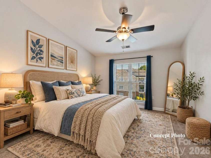 9031 Mcdowell Creek Court, Cornelius, NC 28031.  MLS# CAR4428404, YatesRealty ID 54302. Virtually staged Spacious primary suite featuring plush carpeting, a ceiling fan, and a large window providing abundant natural light and elevated community views.