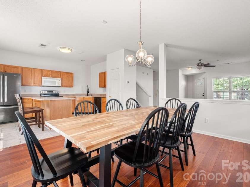 2738 Mill Valley Court, Matthews, NC 28105.  MLS# CAR4424420, YatesRealty ID 54340. Open-concept main level layout showing the fluid transition between the living room, dining space, and functional kitchen setup.