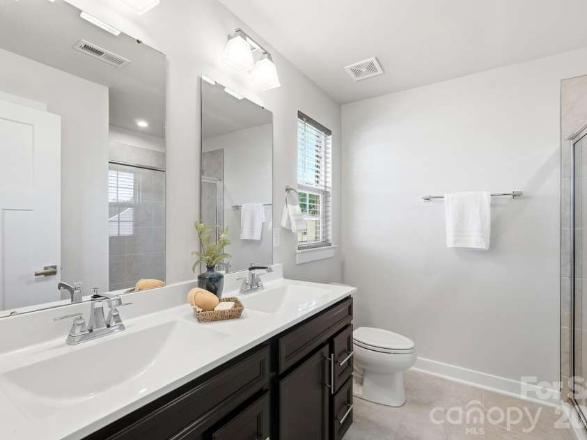1857 Giana Lane, Monroe, NC 28112.  MLS# CAR4422864, YatesRealty ID 54344. Primary bedroom with dual vanities