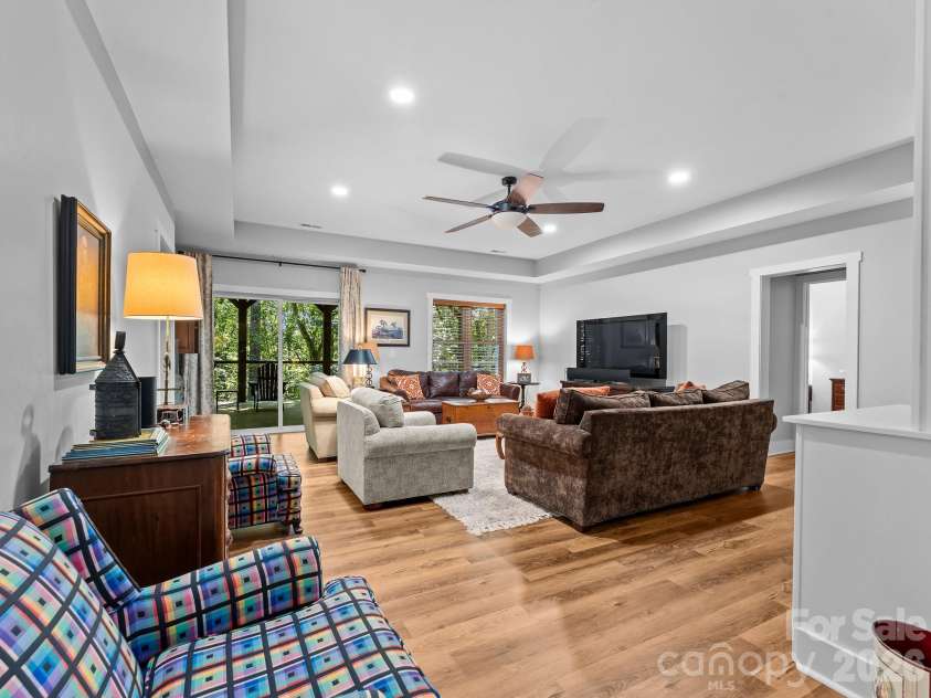 359 New Castle Road, Brevard, NC 28712.  MLS# CAR4427485, YatesRealty ID 54367. Downstairs gathering area between the split bedroom plan