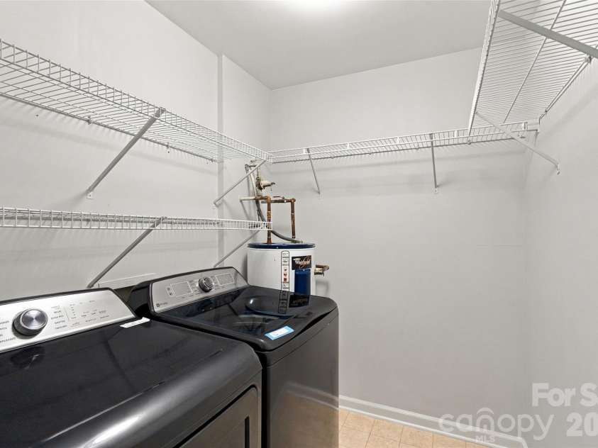 762 Marsh Road, Charlotte, NC 28209.  MLS# CAR4340120, YatesRealty ID 54407. Laundry room with extensive shelving for additional storage. Washer and dryer convey.