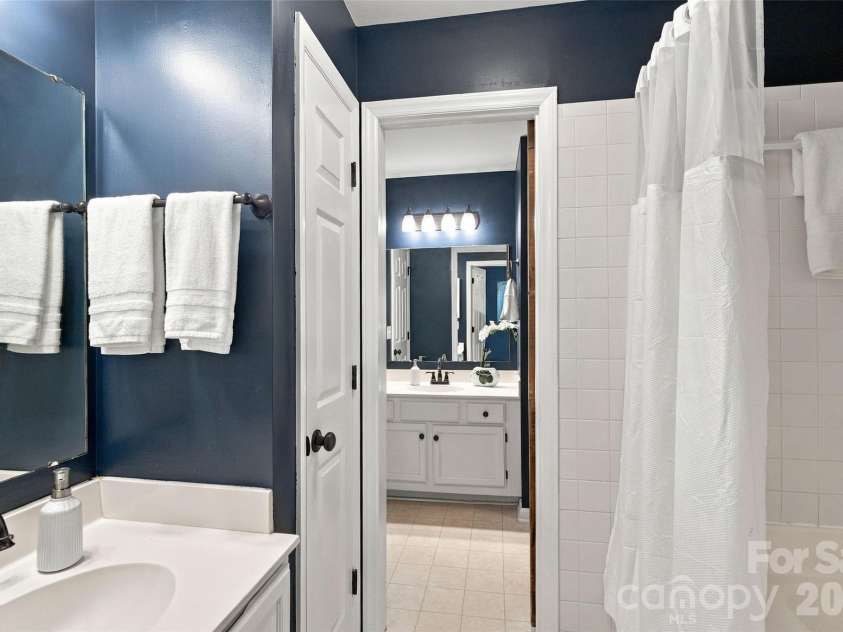 762 Marsh Road, Charlotte, NC 28209.  MLS# CAR4340120, YatesRealty ID 54407. Primary bath with separate vanity area and rich navy walls