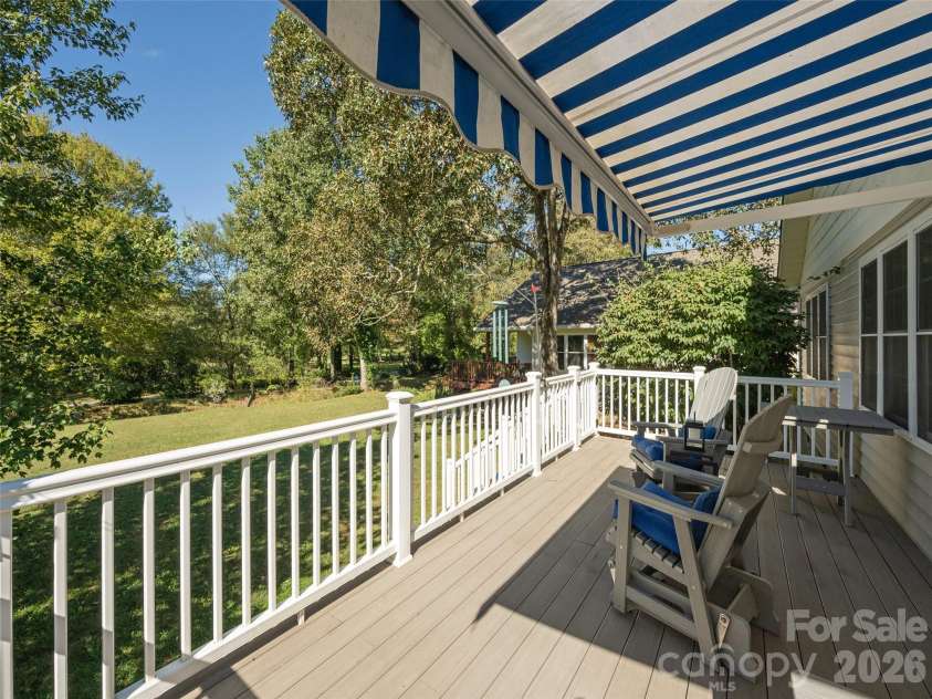 277 Highland Golf Drive, Flat Rock, NC 28731.  MLS# CAR4430345, YatesRealty ID 54429. Large deck with retractable awning.
