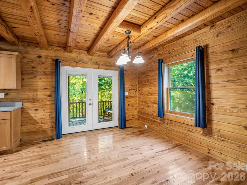 124 Starling Lane, Lake Lure, NC 28746.  MLS# CAR4430565, YatesRealty ID 54465. Dining area and back patio doors