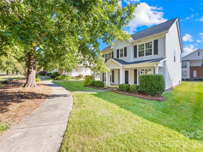 19822 Davidson Concord Road, Davidson, NC 28036.  MLS# CAR4429435, YatesRealty ID 54473. Front side view showing sidewalk and mature shade trees