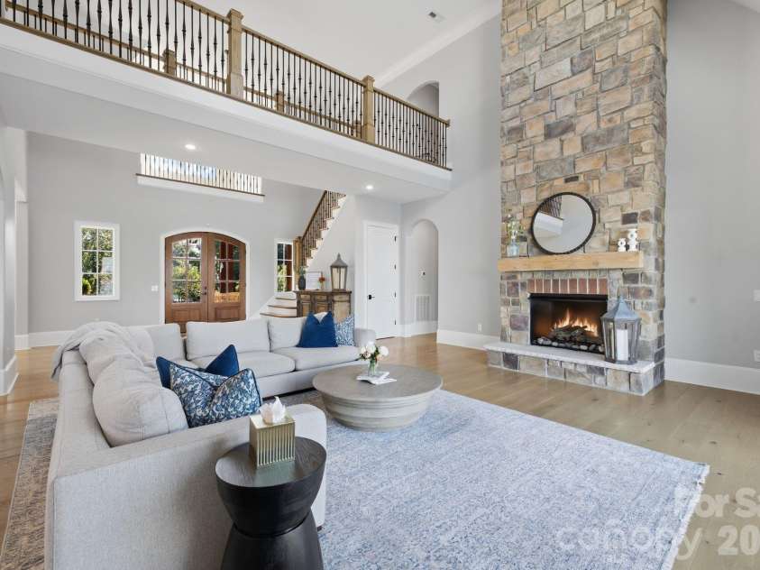 112 Birdsong Lane, Mooresville, NC 28117.  MLS# CAR4430430, YatesRealty ID 54482. Statement fireplace anchors the spacious main-level great room.