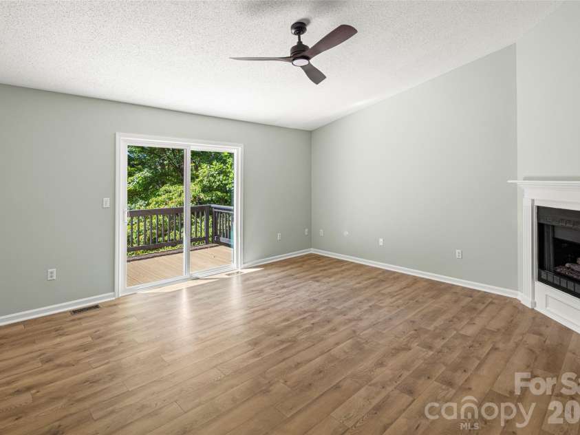 39 Mountain Site Lane, Asheville, NC 28803.  MLS# CAR4430825, YatesRealty ID 54505. Living room looking out to front deck