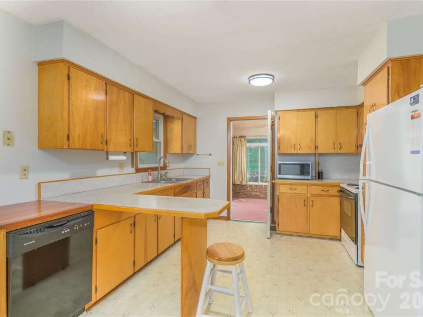 2882 Butler Bridge Road, Mills River, NC 28759.  MLS# CAR4430985, YatesRealty ID 54527. Kitchen to Large 4 Seasons Room