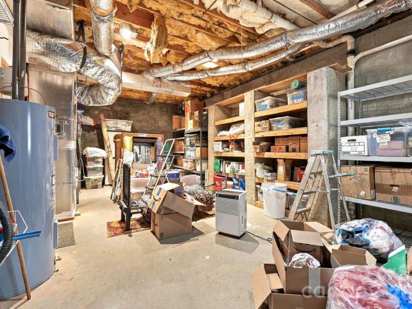 14 Cambridge Drive, Candler, NC 28715.  MLS# CAR4431024, YatesRealty ID 54554. Downstairs Man cave or workshop high ceiling storage