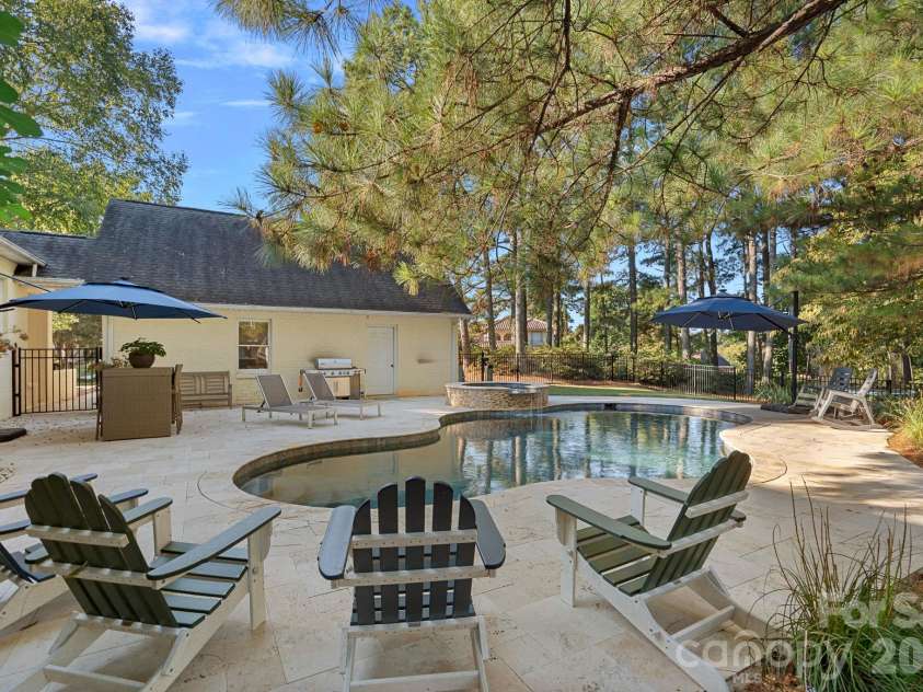 8049 Ravenwood Lane, Stanley, NC 28164.  MLS# CAR4426461, YatesRealty ID 54579. Backyard patio, pool, & spa