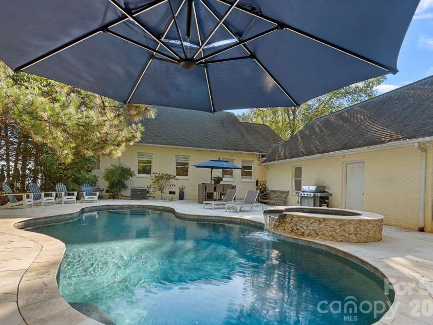 8049 Ravenwood Lane, Stanley, NC 28164.  MLS# CAR4426461, YatesRealty ID 54579. Backyard pool, patio, spa