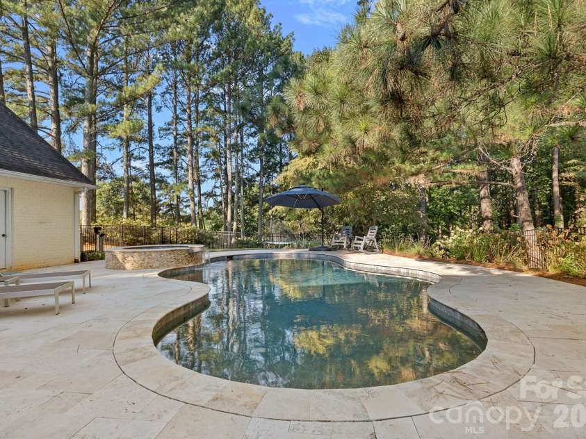 8049 Ravenwood Lane, Stanley, NC 28164.  MLS# CAR4426461, YatesRealty ID 54579. Backyard pool, pool deck, spa