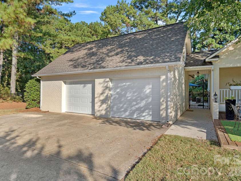 8049 Ravenwood Lane, Stanley, NC 28164.  MLS# CAR4426461, YatesRealty ID 54579. Carriage garage with additional storage
