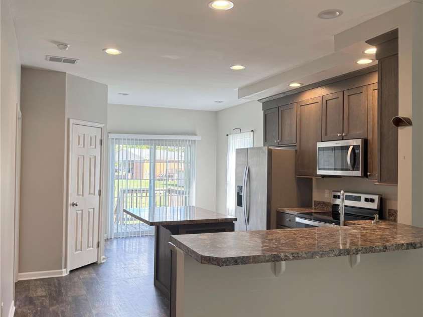 323 Martin Street, Shelby, NC 28150.  MLS# CAR4429863, YatesRealty ID 54603. Living room view into the kitchen and back deck