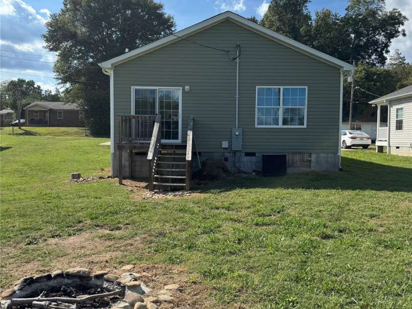 323 Martin Street, Shelby, NC 28150.  MLS# CAR4429863, YatesRealty ID 54603. Open yard with fire pit