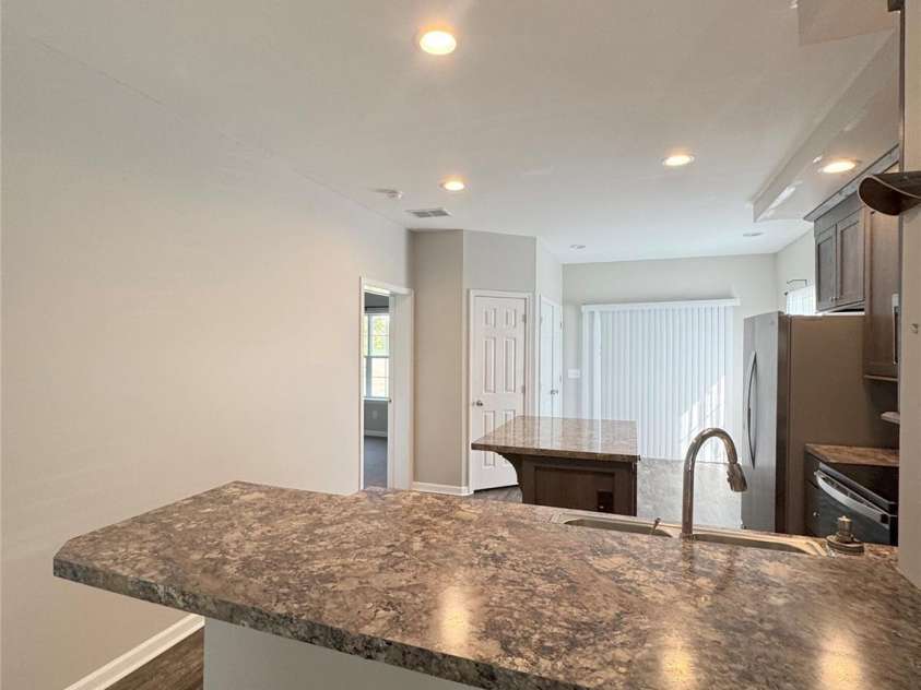 323 Martin Street, Shelby, NC 28150.  MLS# CAR4429863, YatesRealty ID 54603. View from kitchen bar. Primary bedroom on the left door.
