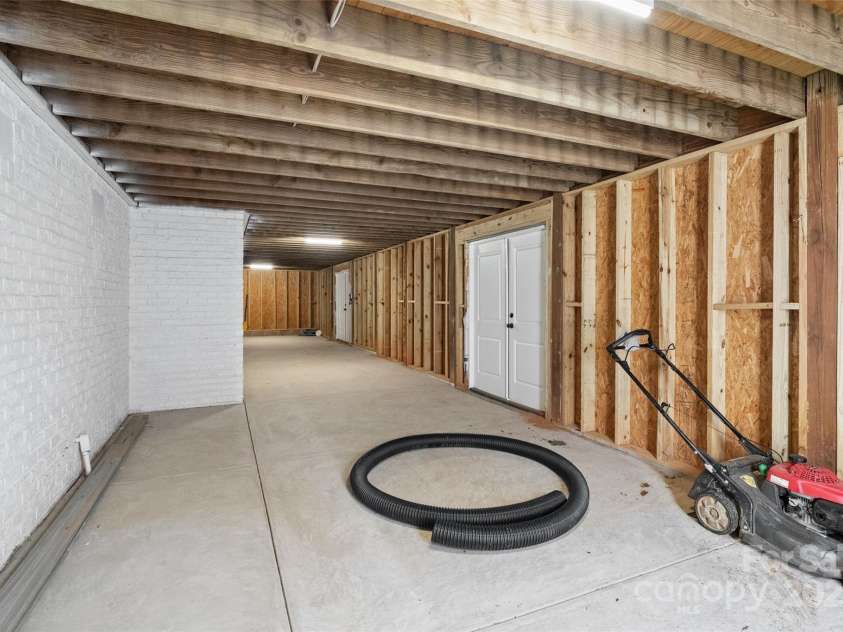 7116 Topsail Circle, Tega Cay, SC 29708.  MLS# CAR4238062, YatesRealty ID 5461. Large unfinished basement area with tiled shower. Easy access from pool or lake.