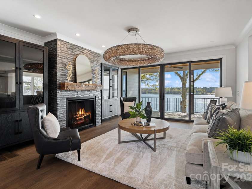 7116 Topsail Circle, Tega Cay, SC 29708.  MLS# CAR4238062, YatesRealty ID 5461. Living room with custom fireplace and lake view