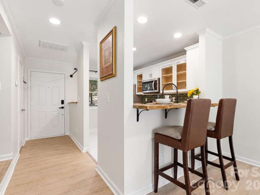 3858 Mosscroft Lane, Charlotte, NC 28215.  MLS# CAR4426479, YatesRealty ID 54623. The breakfast bar creates a convenient setting for coffee, casual meals, and conversation.
