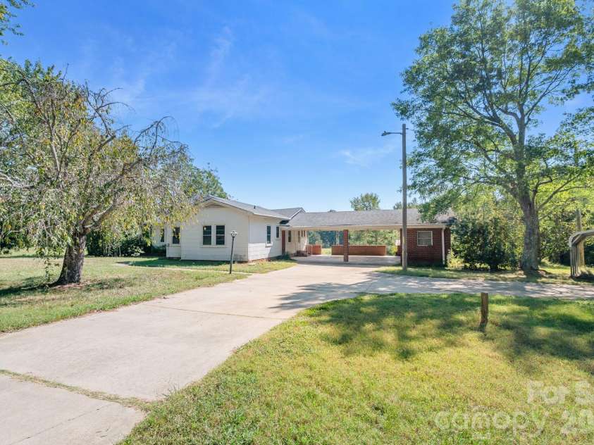 7615 Rocky River Road, Union, NC 28112.  MLS# CAR4430607, YatesRealty ID 54670. Main entry with circular driveway