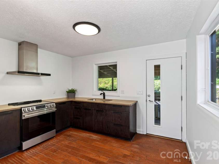 53 Hemlock Street, Arden, NC 28704.  MLS# CAR4430956, YatesRealty ID 54671. Modern kitchen with back deck access