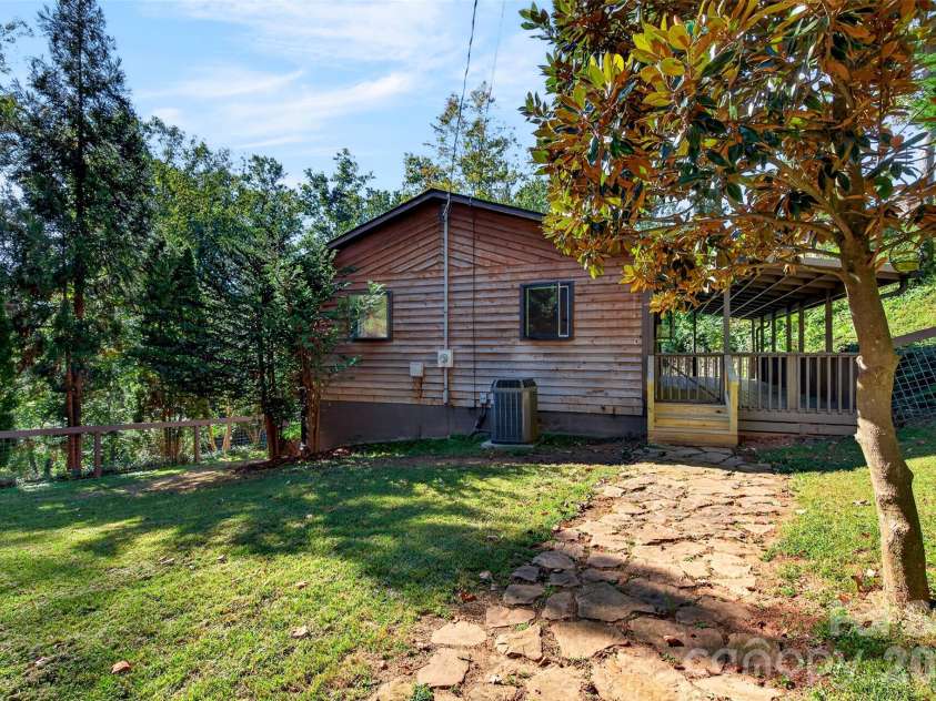 53 Hemlock Street, Arden, NC 28704.  MLS# CAR4430956, YatesRealty ID 54671. View from shed with hardscaping and mature trees
