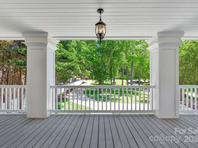 8150 Malibu Pointe Lane, Denver, NC 28037.  MLS# CAR4234717, YatesRealty ID 5468. Front balcony overlooks front lawn with mature trees.
