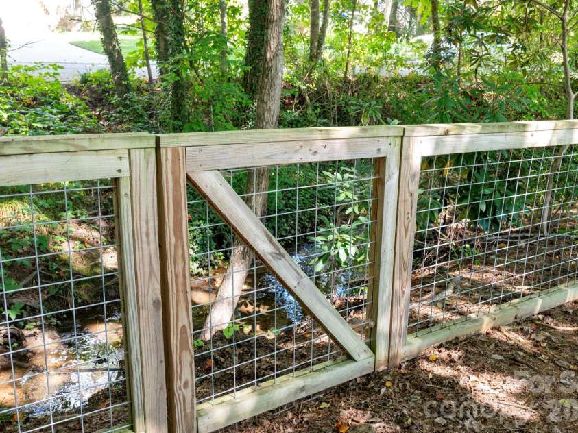 340 Genesis Circle, Black Mountain, NC 28711.  MLS# CAR4429667, YatesRealty ID 54851. Back Yard Fence and Running Stream