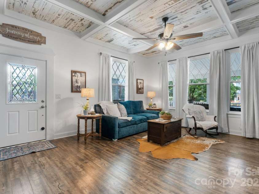 704 Main Avenue, Newton, NC 28658.  MLS# CAR4275934, YatesRealty ID 5489. Living room overlooking wrap around front porch - updated windows.