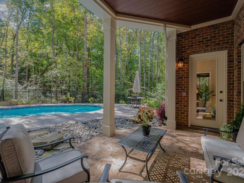 7029 Pebble Bay Drive, Denver, NC 28037.  MLS# CAR4192335, YatesRealty ID 5495. Outside patio overlooking the private yard and pool.