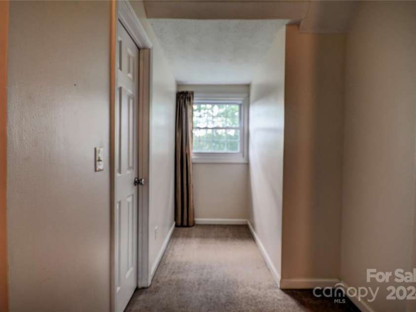 201 Acorn Lane, Clyde, NC 28721.  MLS# CAR4153632, YatesRealty ID 5499. Bedroom 2 Dormer Window, mechanical closet to the right houses the upper-level air handler