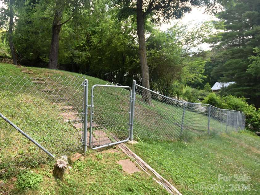201 Acorn Lane, Clyde, NC 28721.  MLS# CAR4153632, YatesRealty ID 5499. Fenced area for pets on the side