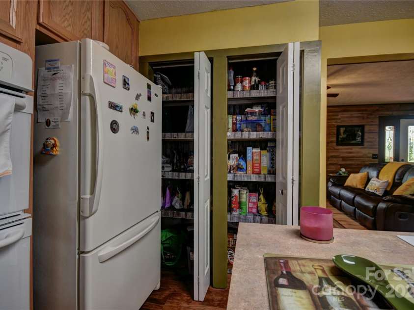 201 Acorn Lane, Clyde, NC 28721.  MLS# CAR4153632, YatesRealty ID 5499. Pantry next to the refrigerator