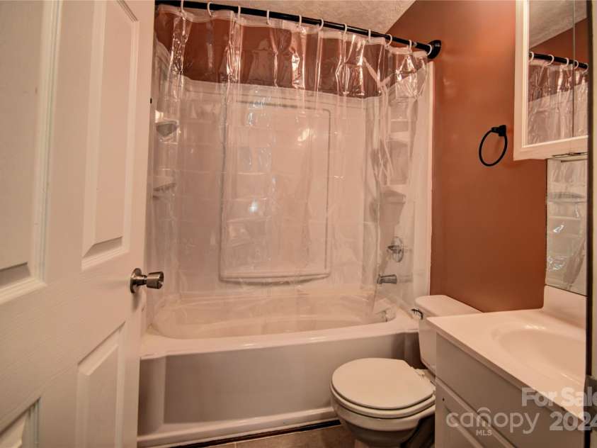 201 Acorn Lane, Clyde, NC 28721.  MLS# CAR4153632, YatesRealty ID 5499. Upper-Level Bath at the top of the stairs