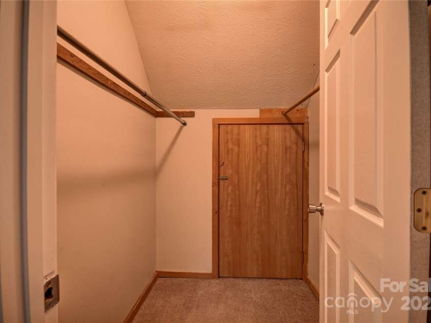 201 Acorn Lane, Clyde, NC 28721.  MLS# CAR4153632, YatesRealty ID 5499. Walk-In Closet off BR 2 with access to storage